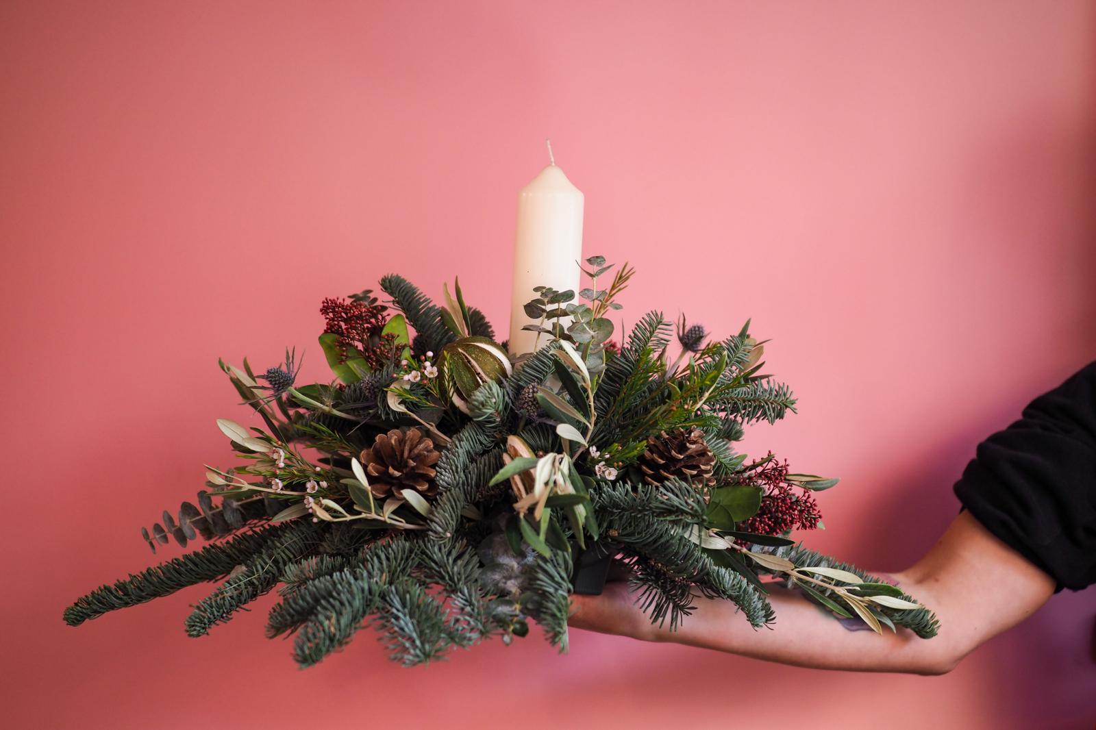 Image showing a festive table decoration, complete with seasonal foliage and candle.